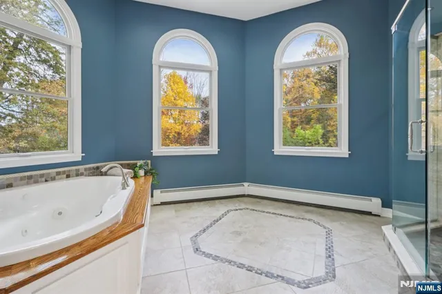 a bath tub sitting next to a window