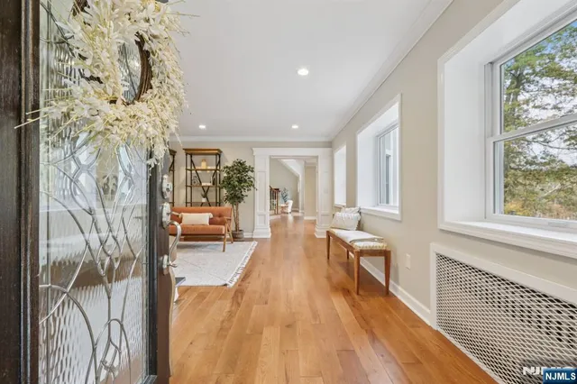 a living room with a large window and wooden floor