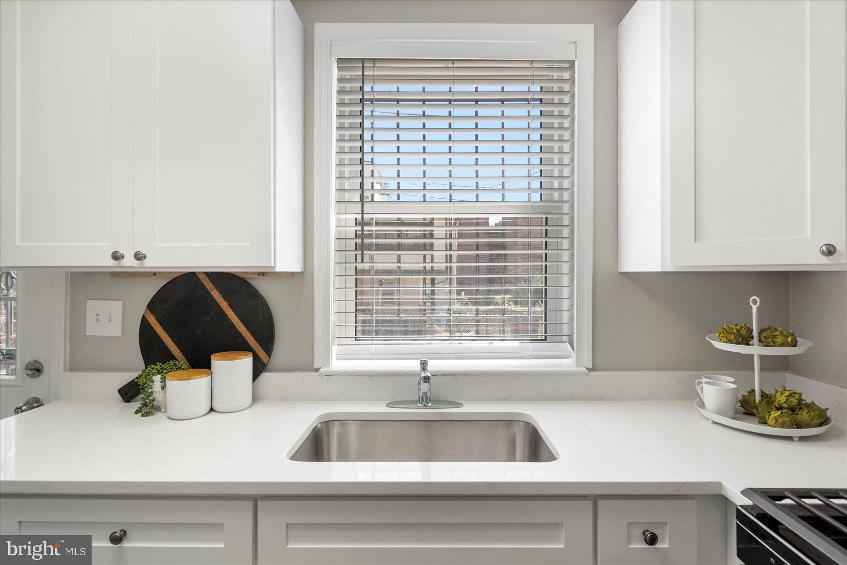 535 Mosher Street Baltimore, MD 21217 - Photo 14 of 28 a kitchen with a sink and a stove next to a window