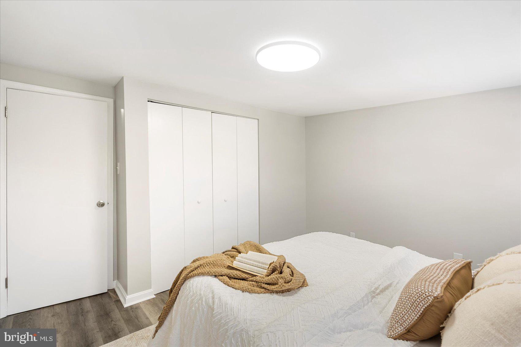 535 Mosher Street Baltimore, MD 21217 - Photo 17 of 28 a bedroom with a bed and a wooden floor