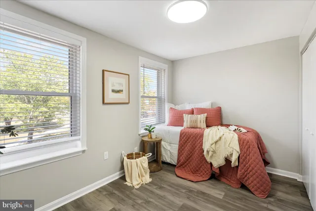 a bed sitting in a bedroom next to a window