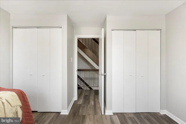 a view of closet with wooden floor