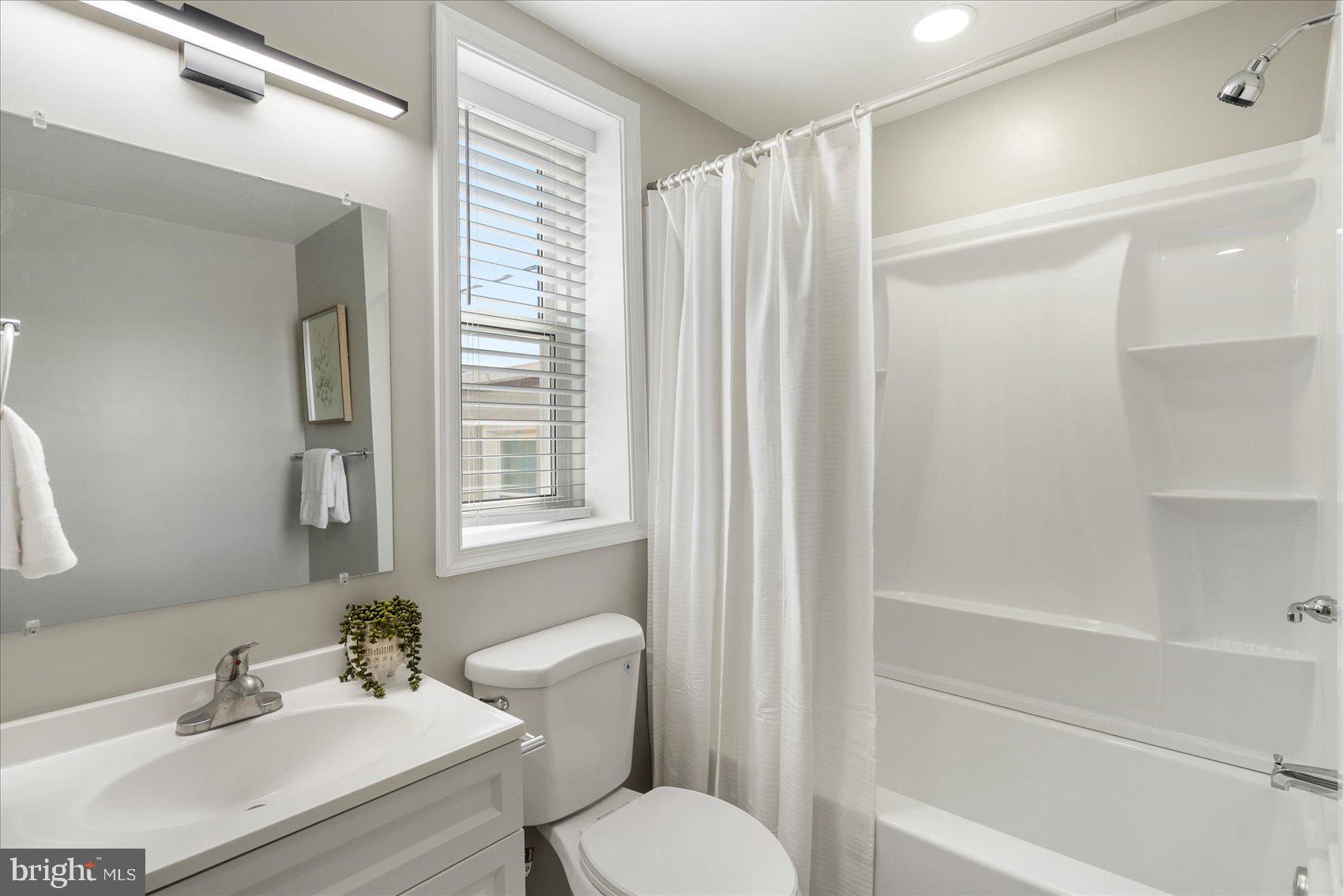 535 Mosher Street Baltimore, MD 21217 - Photo 23 of 28 a bathroom with a sink toilet and shower