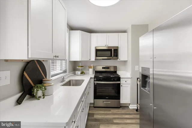 a kitchen with a sink appliances and cabinets