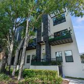 front view of a house with a tree