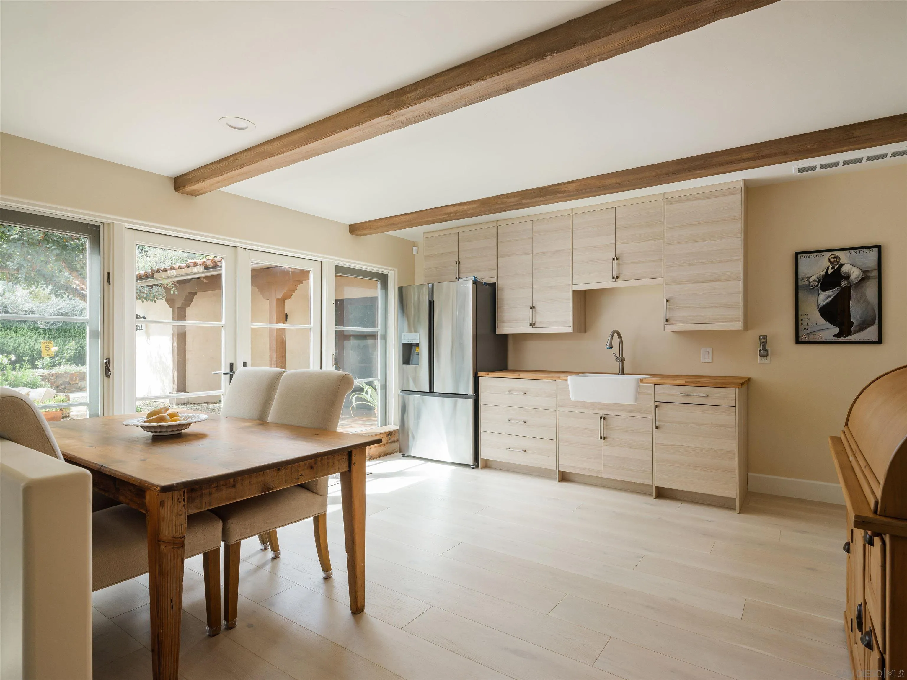16338 Via Del Alba Rancho Santa Fe, CA 92067 - Photo 33 of 46 a kitchen with a table chairs and refrigerator