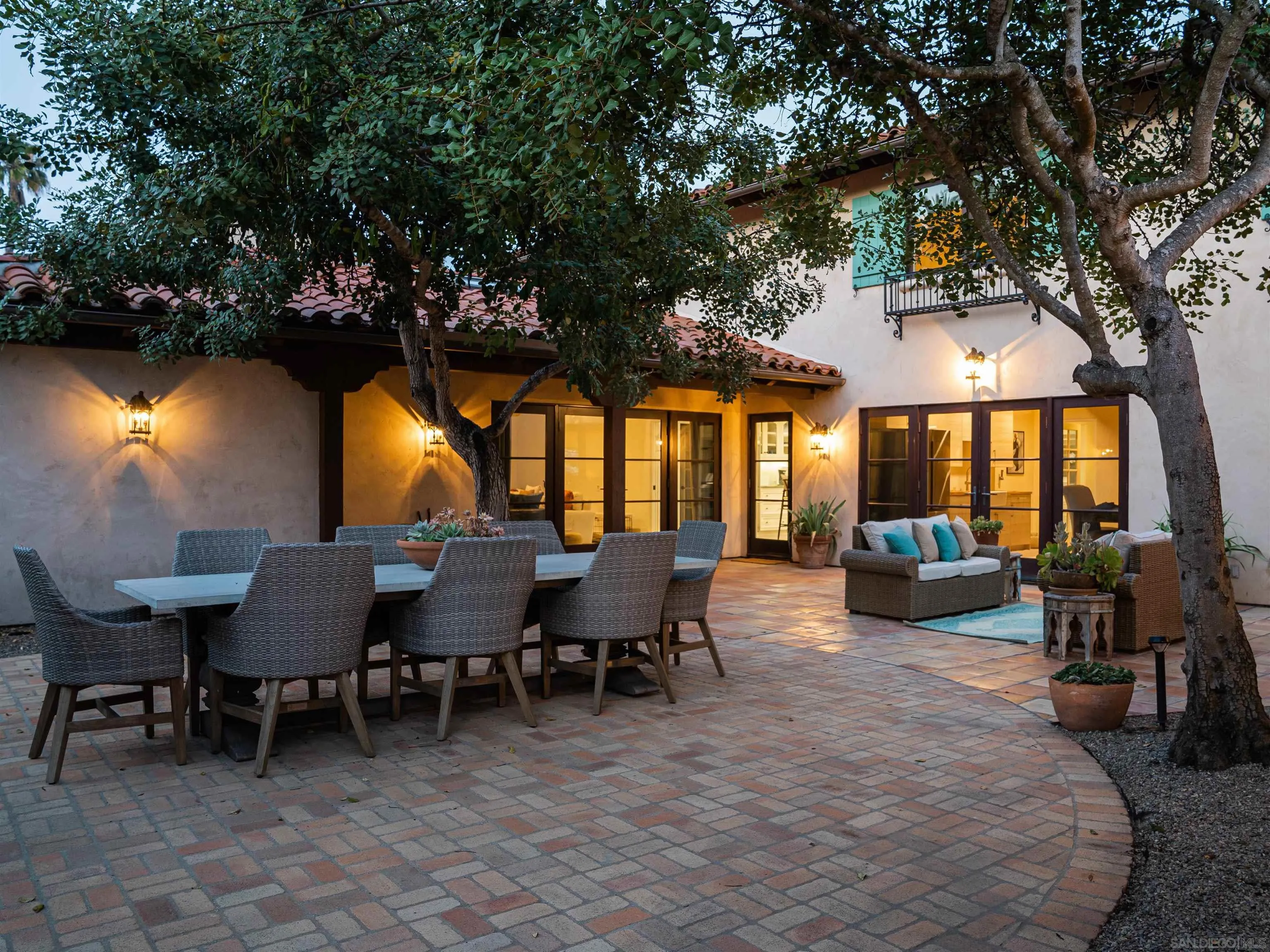 16338 Via Del Alba Rancho Santa Fe, CA 92067 - Photo 8 of 46 a view of a patio with dining table and chairs with a large tree