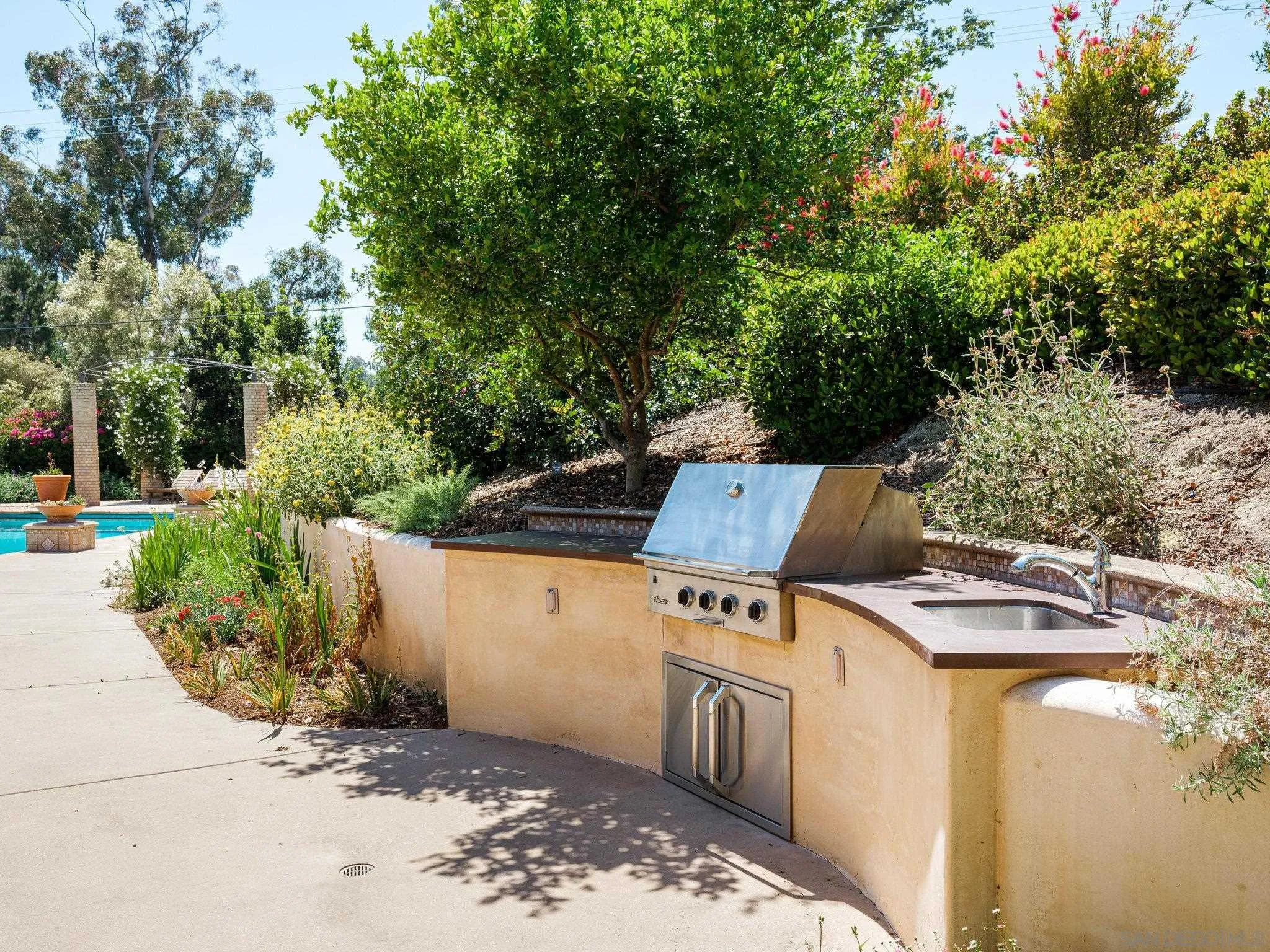 16338 Via Del Alba Rancho Santa Fe, CA 92067 - Photo 10 of 46 a view of a backyard with chairs and a stove