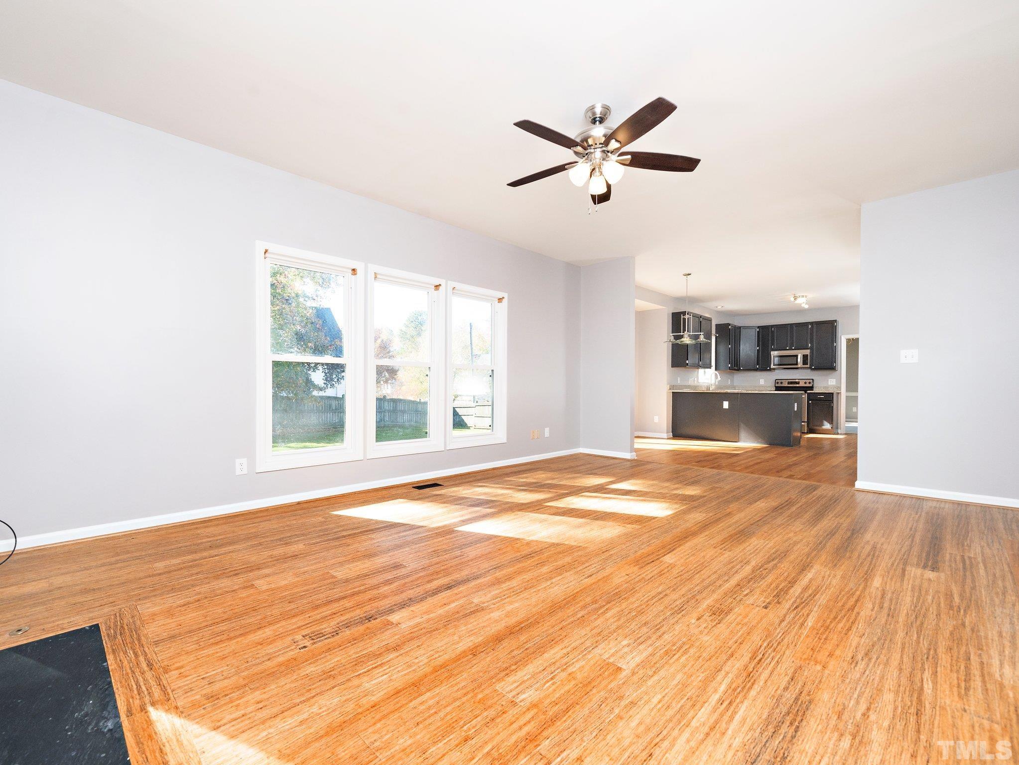 9821 Rockledge Drive Raleigh, NC 27617 - Photo 13 of 26 a view of empty room with wooden floor and window