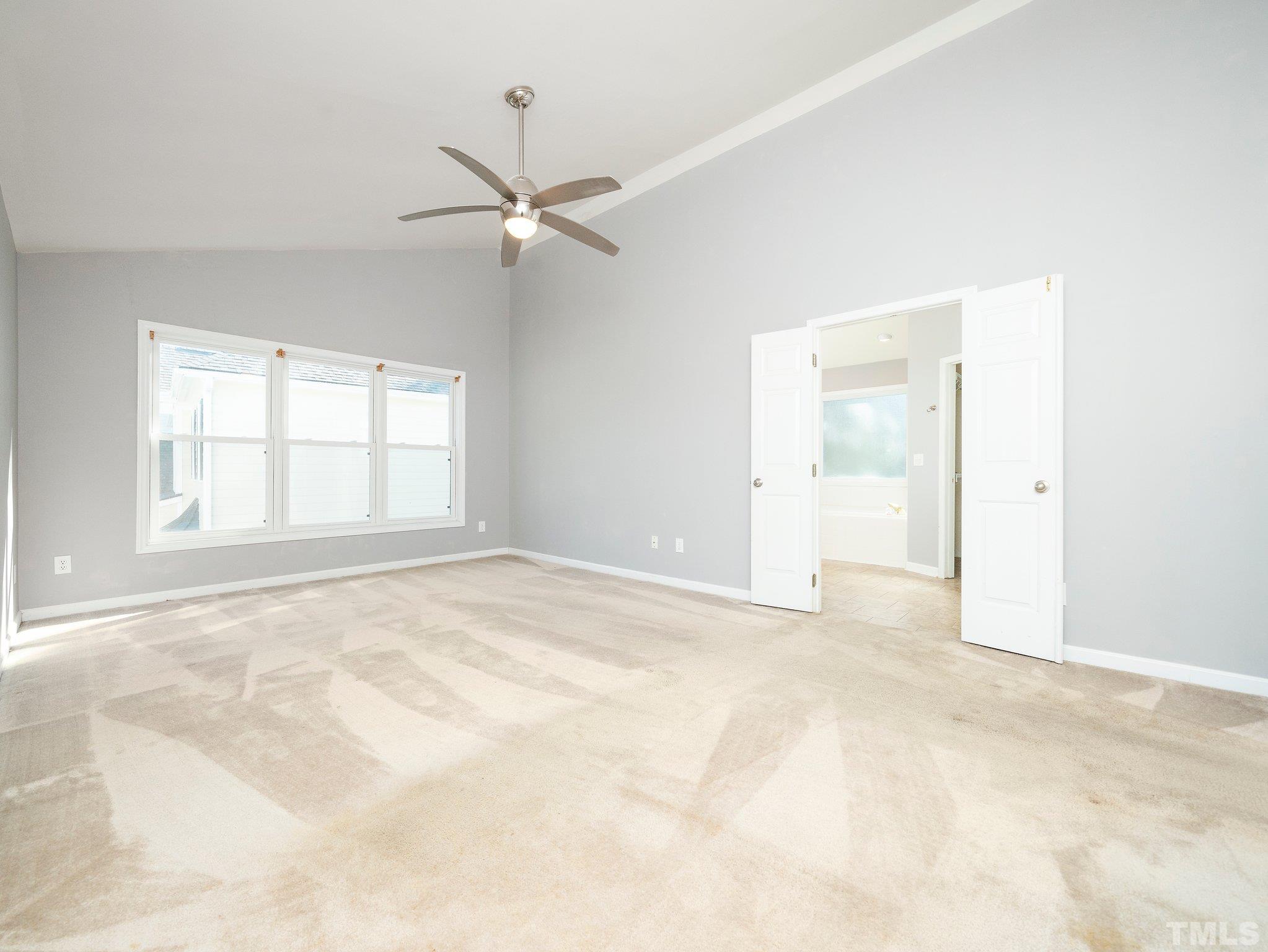 9821 Rockledge Drive Raleigh, NC 27617 - Photo 16 of 26 an empty room with windows and fan
