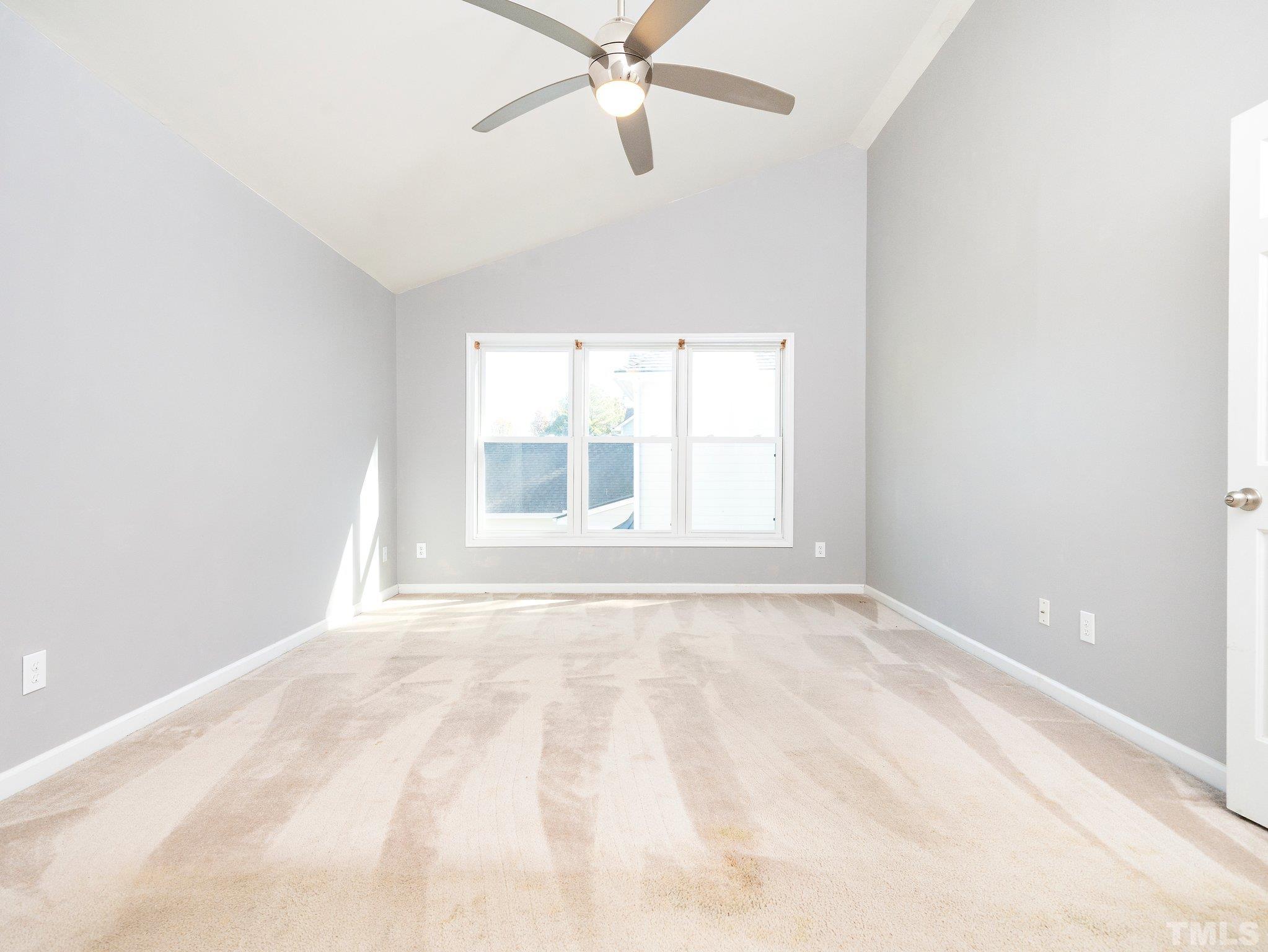 9821 Rockledge Drive Raleigh, NC 27617 - Photo 17 of 26 an empty room with a window and ceiling fan