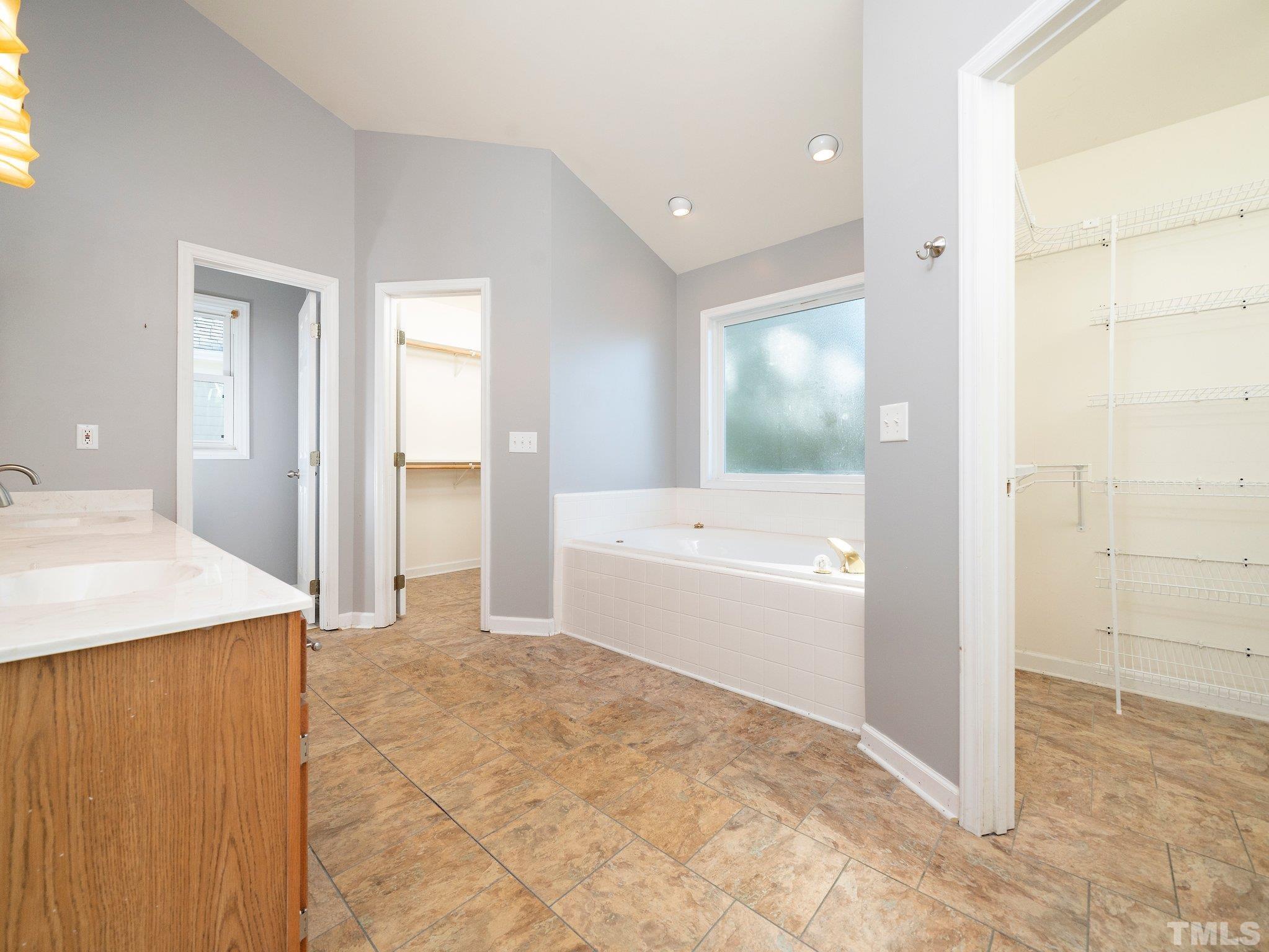 9821 Rockledge Drive Raleigh, NC 27617 - Photo 18 of 26 a bathroom with a tub shower and sink