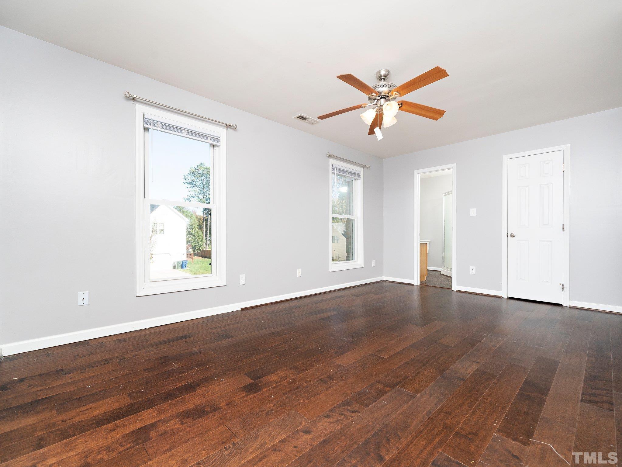 9821 Rockledge Drive Raleigh, NC 27617 - Photo 21 of 26 a view of an empty room with wooden floor and a window