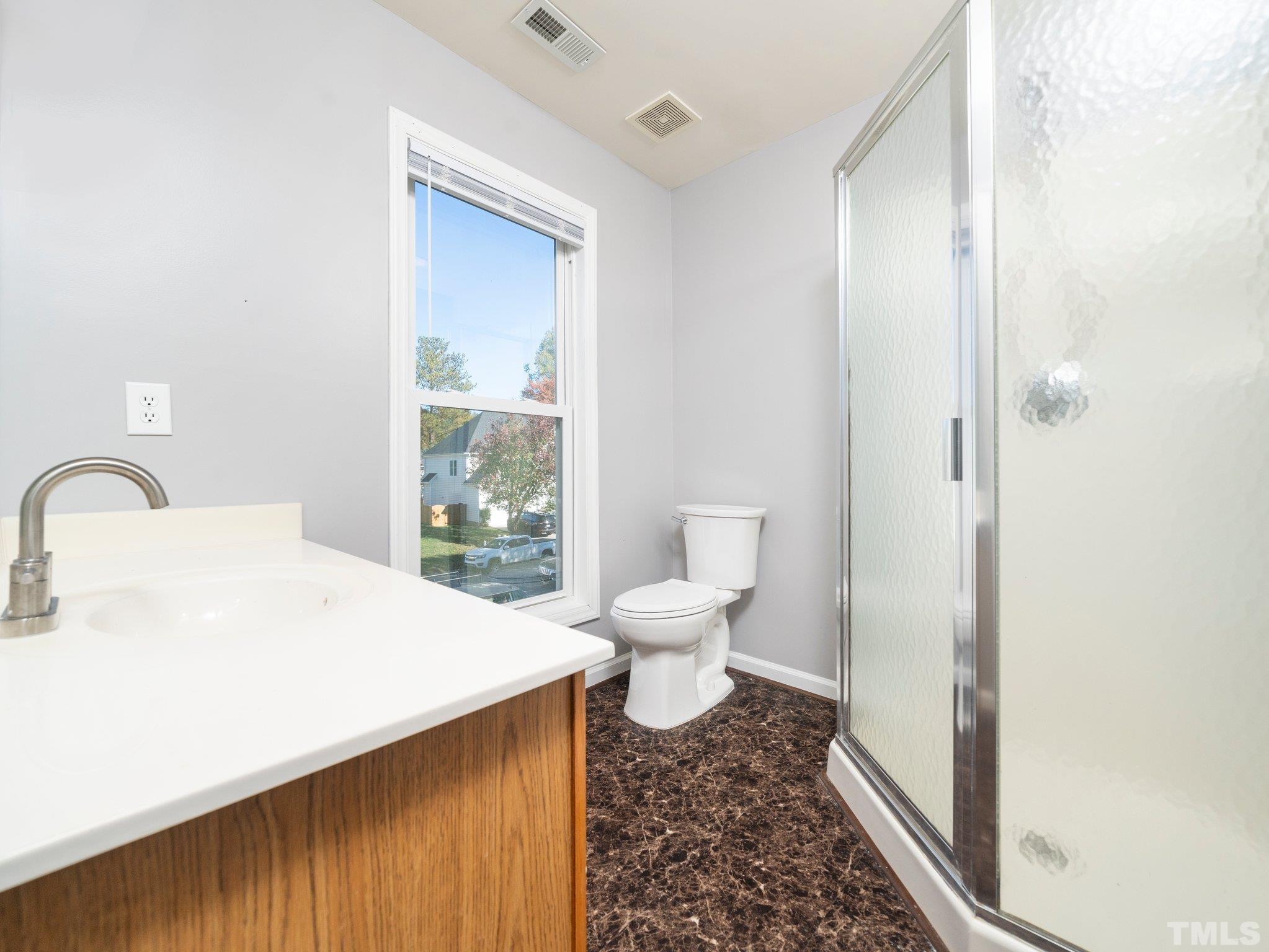 9821 Rockledge Drive Raleigh, NC 27617 - Photo 22 of 26 a bathroom with a sink toilet and shower
