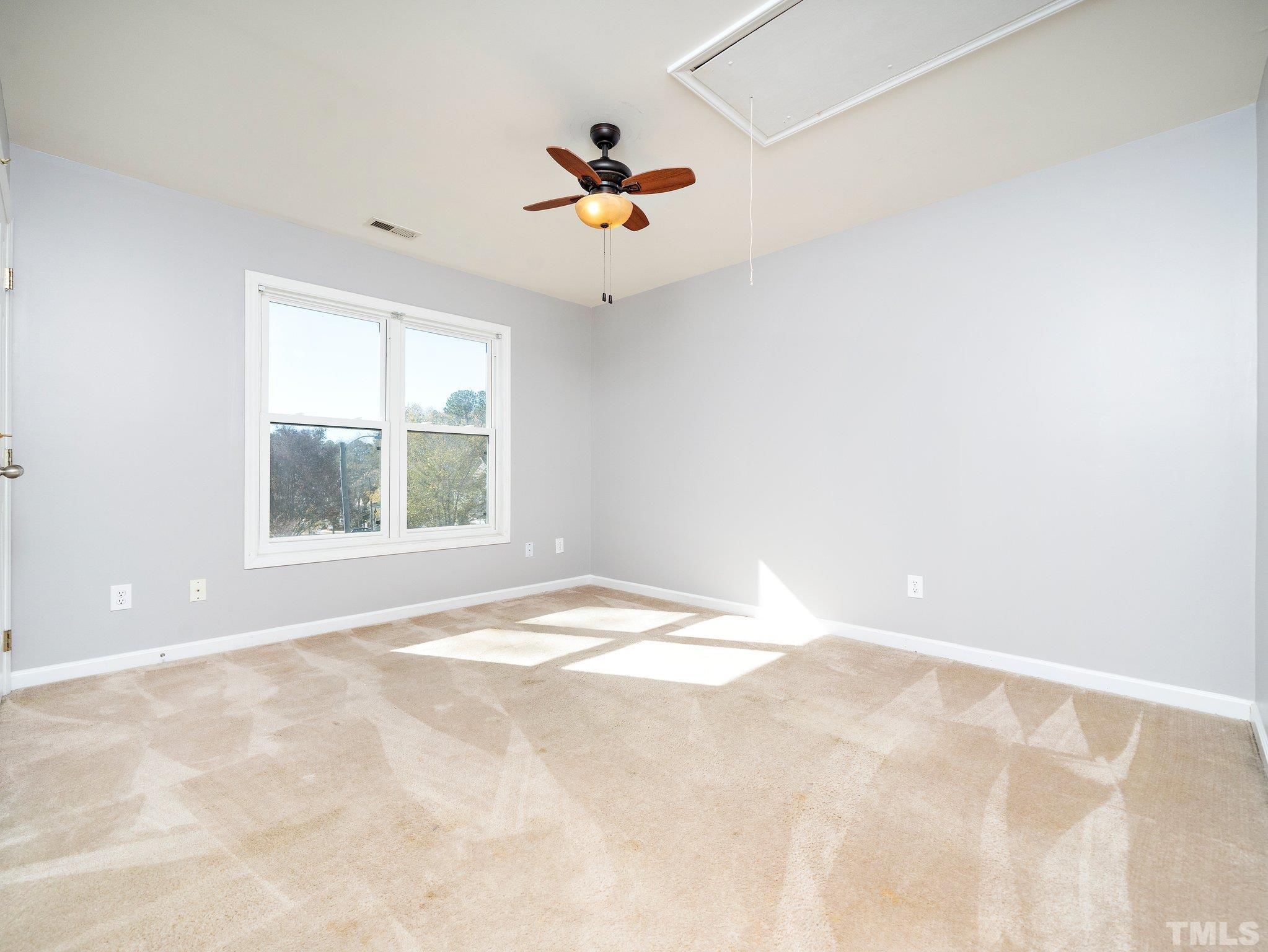 9821 Rockledge Drive Raleigh, NC 27617 - Photo 23 of 26 an empty room with windows and cabinet