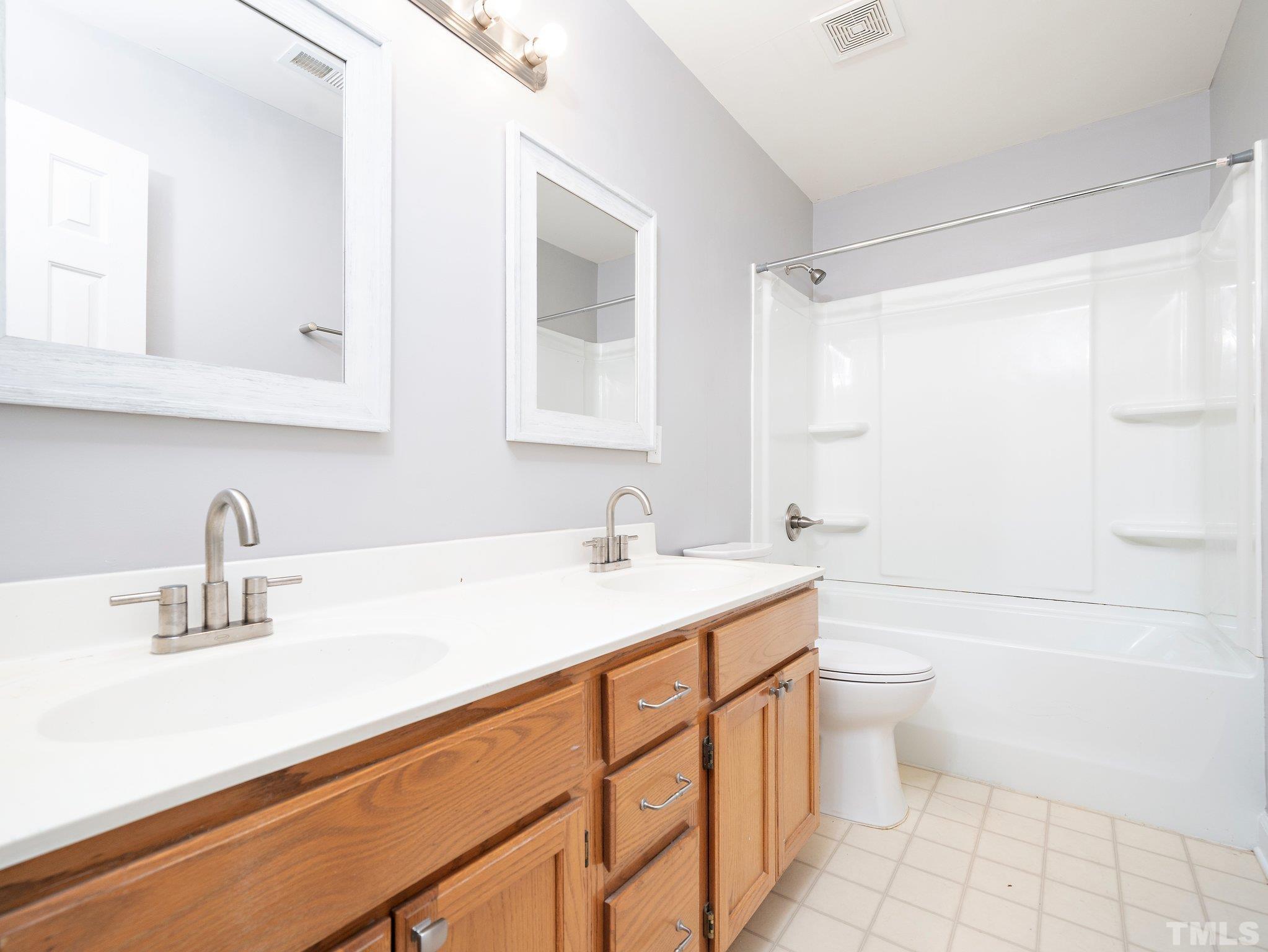 9821 Rockledge Drive Raleigh, NC 27617 - Photo 24 of 26 a bathroom with a sink a toilet and shower