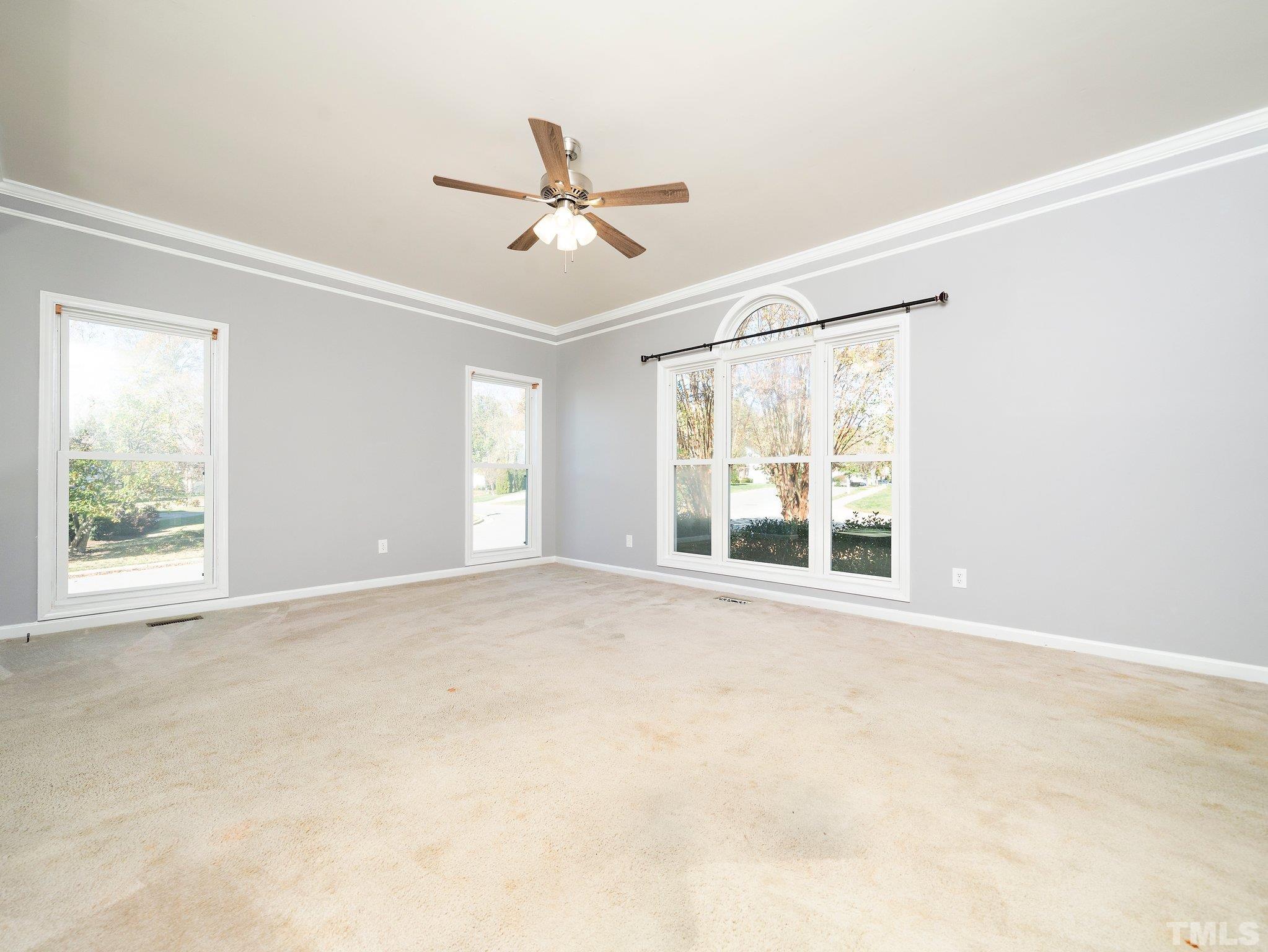 9821 Rockledge Drive Raleigh, NC 27617 - Photo 6 of 26 a view of an empty room with a window
