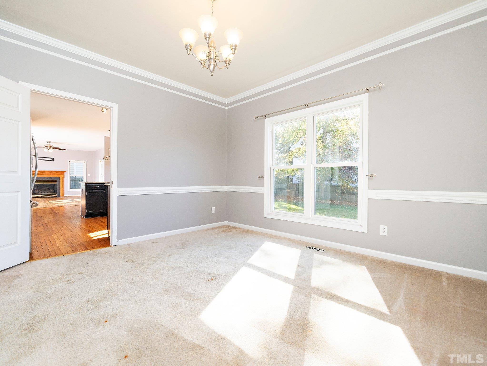 9821 Rockledge Drive Raleigh, NC 27617 - Photo 8 of 26 a view of an empty room with a window