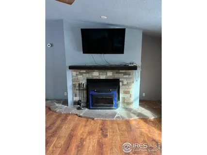 a living room with a fireplace and a flat screen tv
