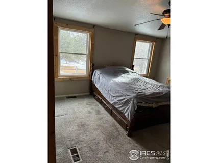 a bed room with a bed and a chandelier