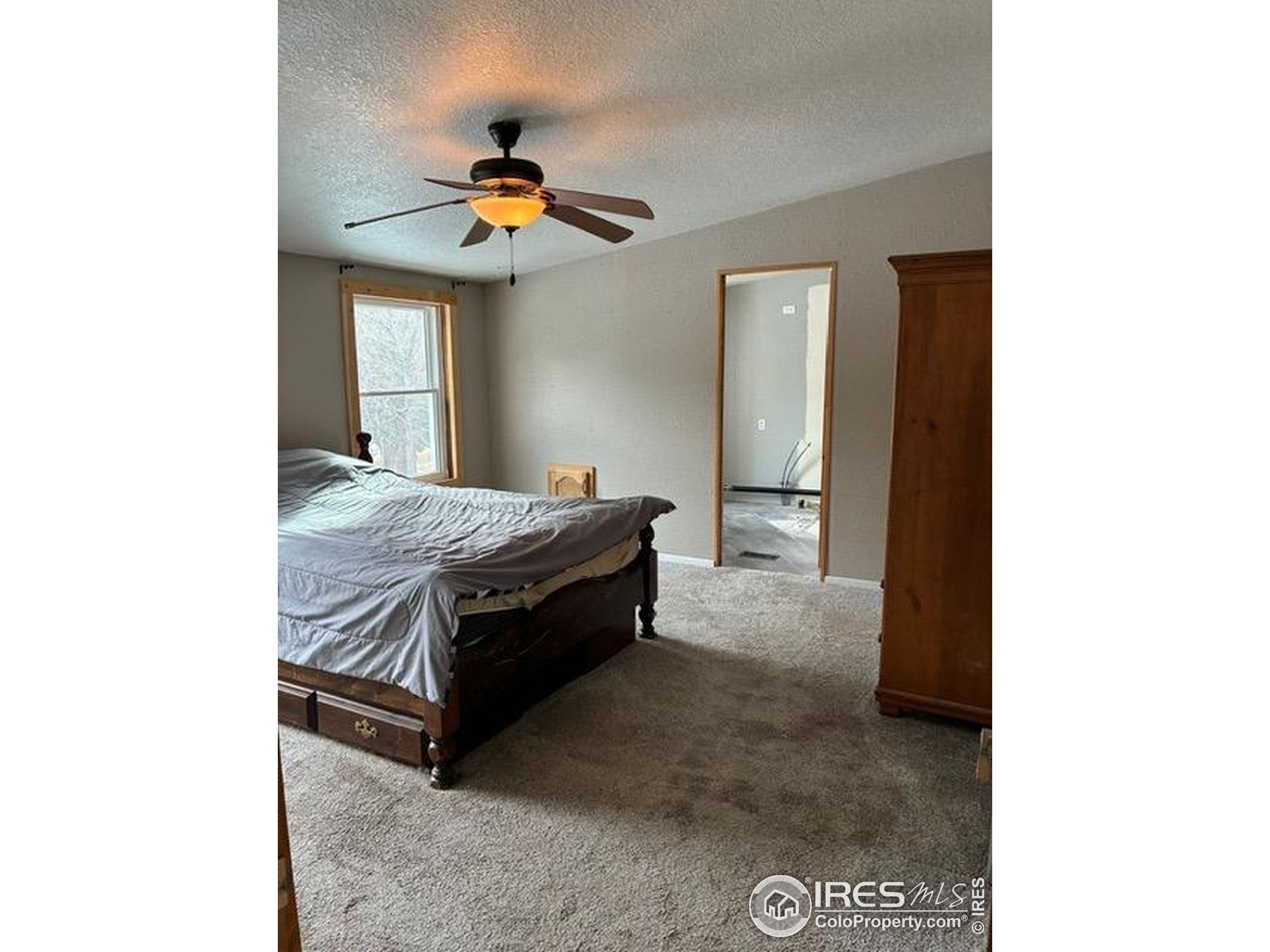 1759 Arapahoe Drive Florissant, CO 80816 - Photo 18 of 40 a bed room with a bed and a chandelier
