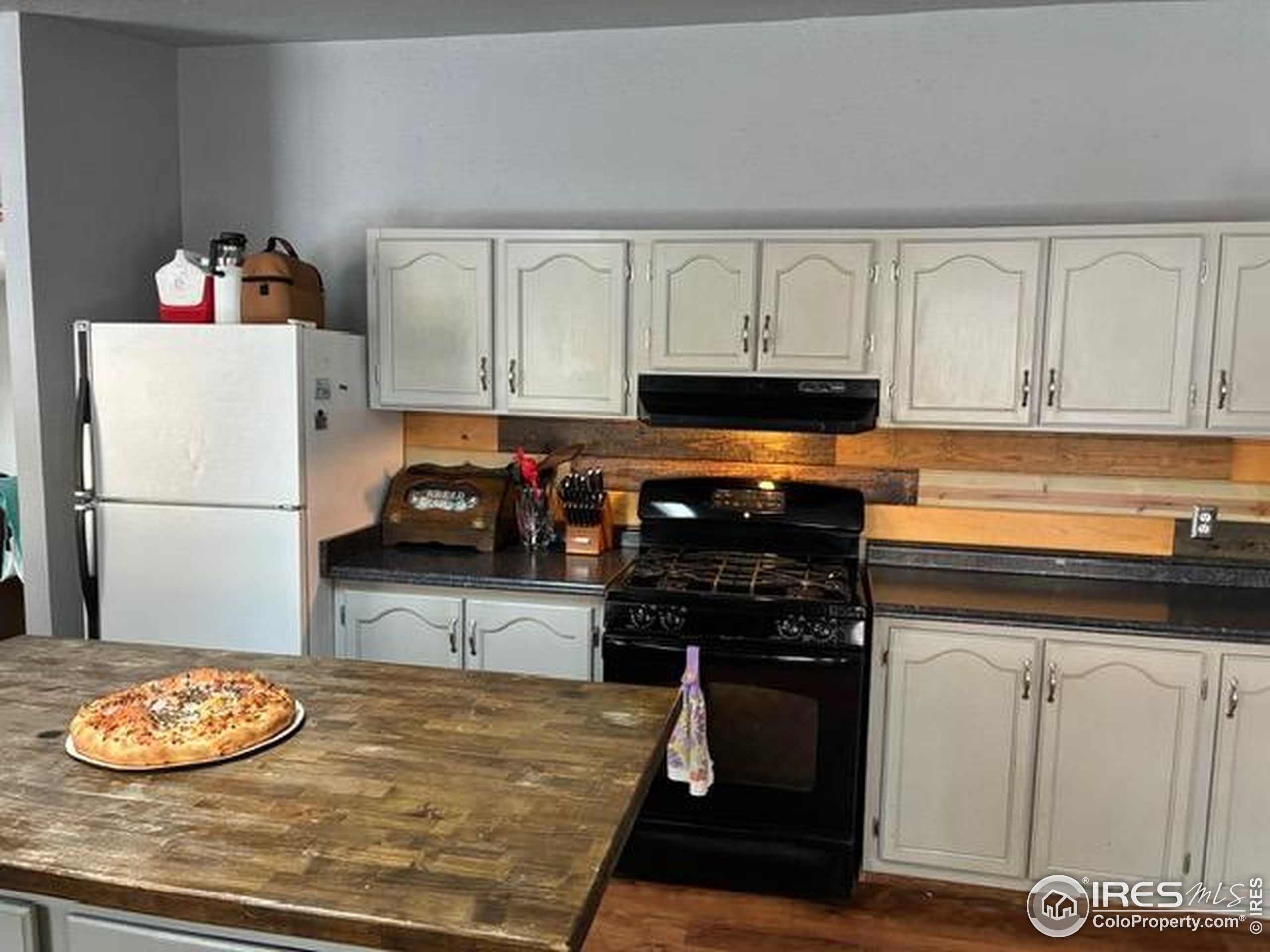 1759 Arapahoe Drive Florissant, CO 80816 - Photo 7 of 40 a kitchen with a refrigerator and a stove top oven