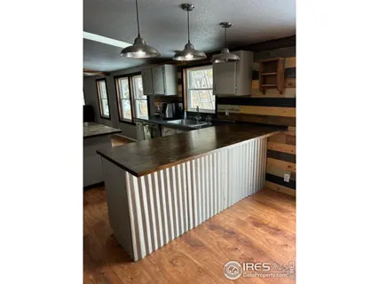 a kitchen with a sink a counter top space and stainless steel appliances