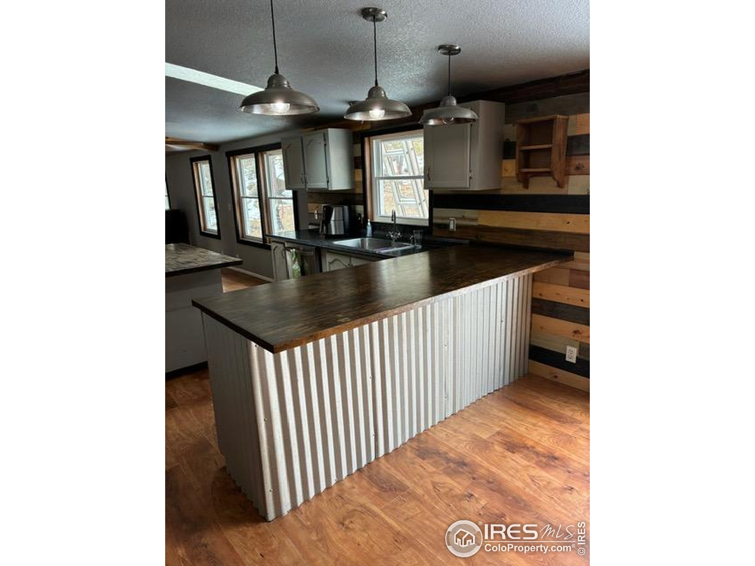 1759 Arapahoe Drive Florissant, CO 80816 - Photo 8 of 40 a kitchen with a sink a counter top space and stainless steel appliances