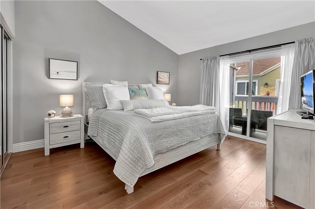 34014 Selva Road, Unit 19 Dana Point, CA 92629 - Photo 12 of 19 a bedroom with a bed and wooden floor