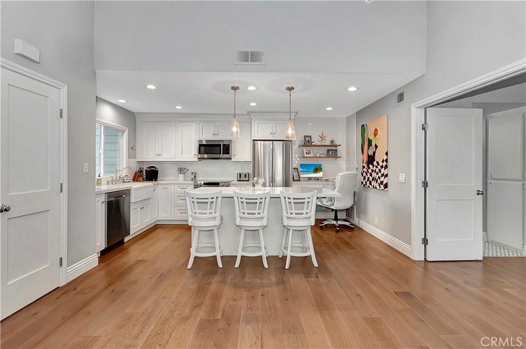 34014 Selva Road, Unit 19 Dana Point, CA 92629 - Photo 5 of 19 a view of a dining room kitchen with furniture and wooden floor