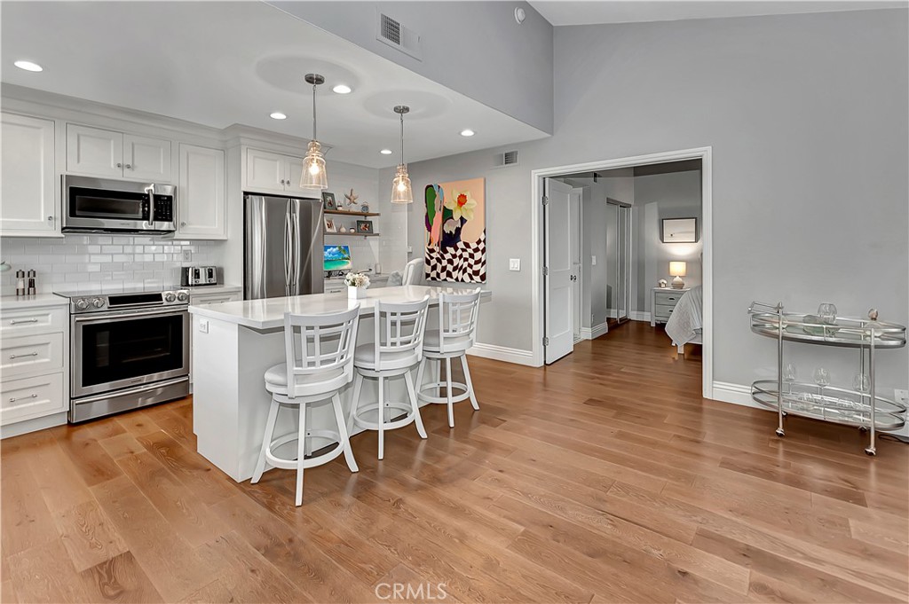 34014 Selva Road, Unit 19 Dana Point, CA 92629 - Photo 6 of 19 a view of a dining room with furniture wooden floor and a chandelier