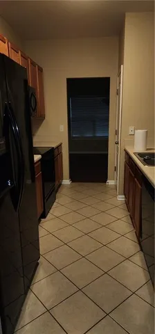 a kitchen with a refrigerator and a stove