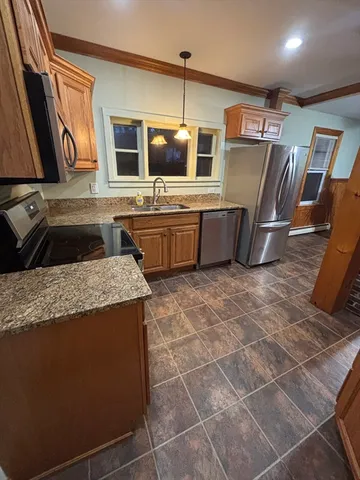 a kitchen with stainless steel appliances granite countertop a sink and a microwave