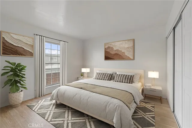 a bedroom with a bed and a potted plant