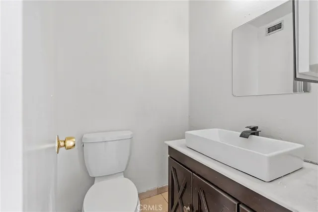 a white toilet sitting next to a bathroom sink