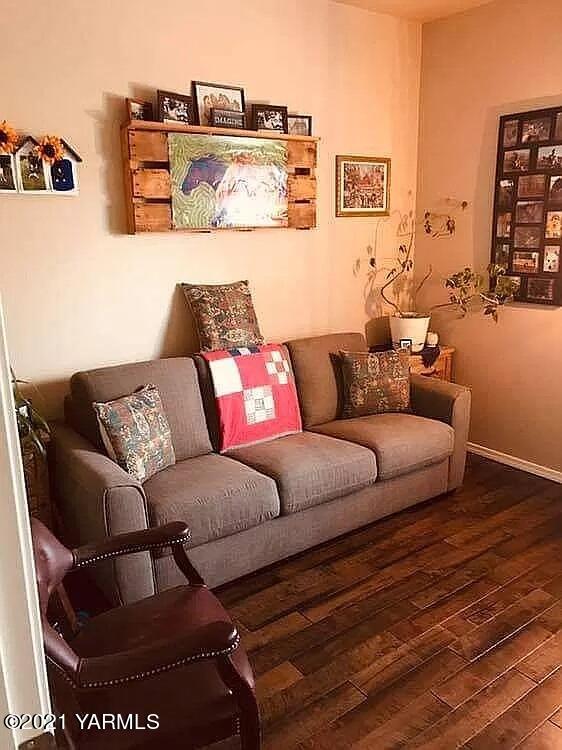 7302 South Moore Road Prosser, WA 99350 - Photo 10 of 24 a living room with furniture and a wooden floor