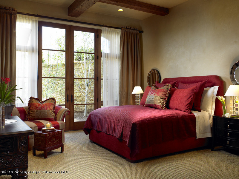 1518 West Buttermilk Road Aspen, CO 81611 - Photo 15 of 40 a bedroom with a bed and a couch next to a window