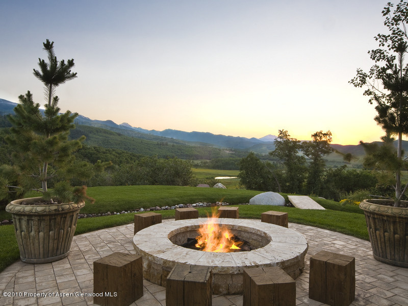 1518 West Buttermilk Road Aspen, CO 81611 - Photo 26 of 40 a patio with a table and chairs and a potted plants