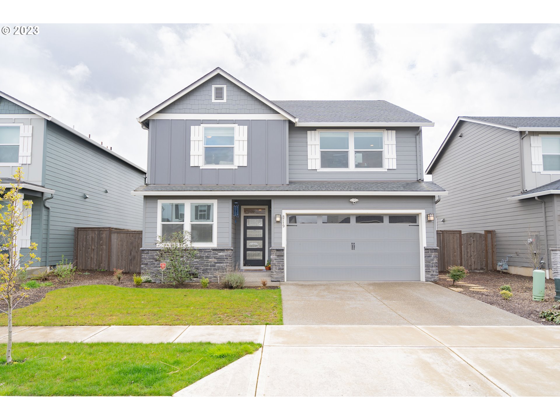 8719 North 1st Street Ridgefield, WA 98642 - Photo 1 of 45 a front view of a house with swimming pool and a garden