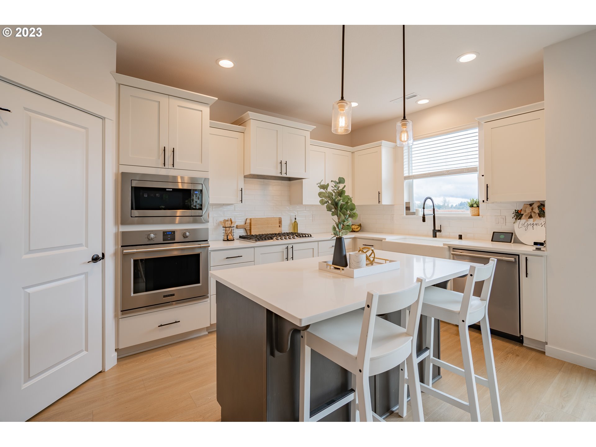 8719 North 1st Street Ridgefield, WA 98642 - Photo 12 of 45 a kitchen with a table chairs microwave and cabinets