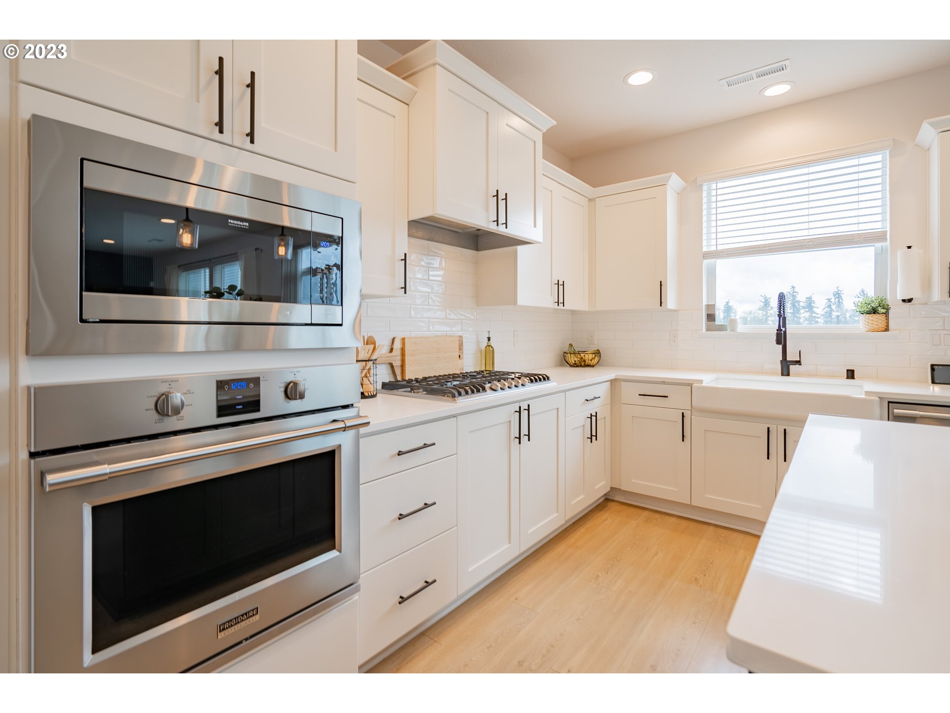 8719 North 1st Street Ridgefield, WA 98642 - Photo 14 of 45 a kitchen with stainless steel appliances white cabinets and a stove