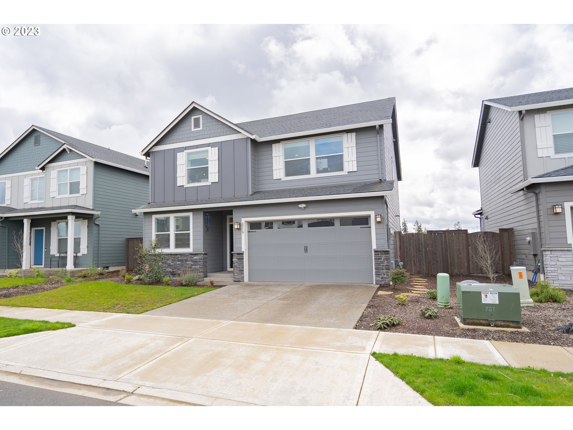 8719 North 1st Street Ridgefield, WA 98642 - Photo 2 of 45 a front view of a house with garden and plants