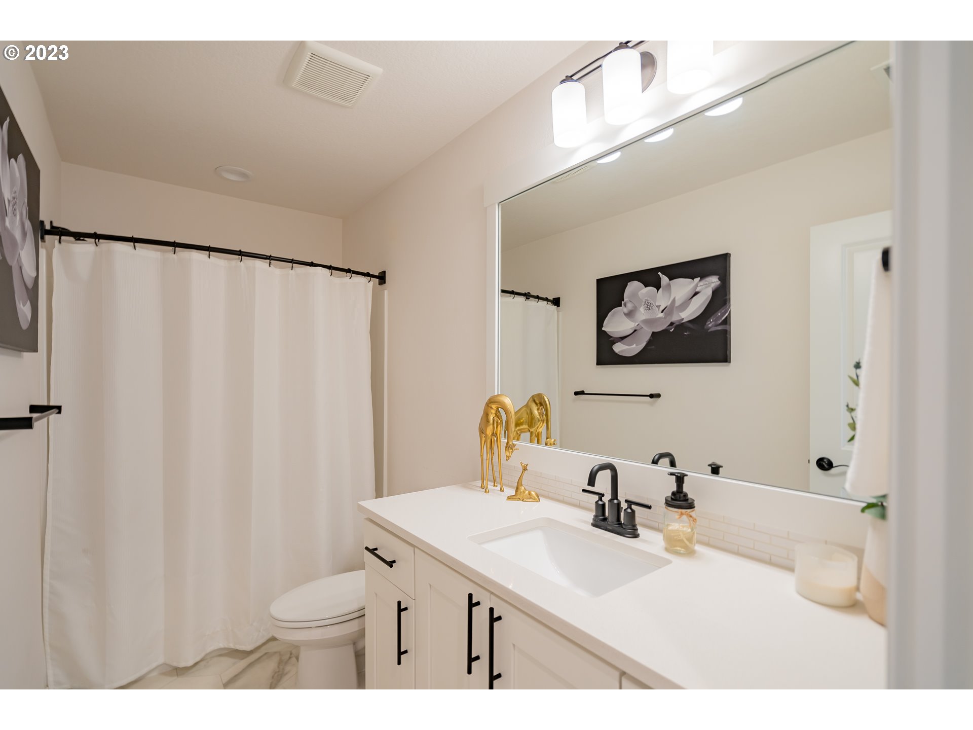 8719 North 1st Street Ridgefield, WA 98642 - Photo 21 of 45 a bathroom with a sink vanity mirror and a toilet