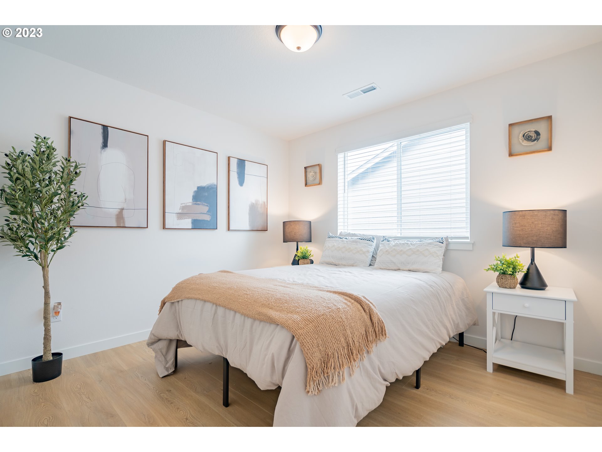 8719 North 1st Street Ridgefield, WA 98642 - Photo 31 of 45 a bedroom with a bed and a potted plant