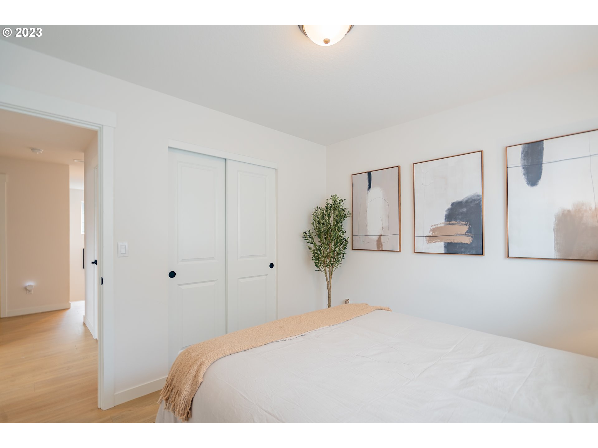 8719 North 1st Street Ridgefield, WA 98642 - Photo 32 of 45 a bedroom with a bed and a potted plant