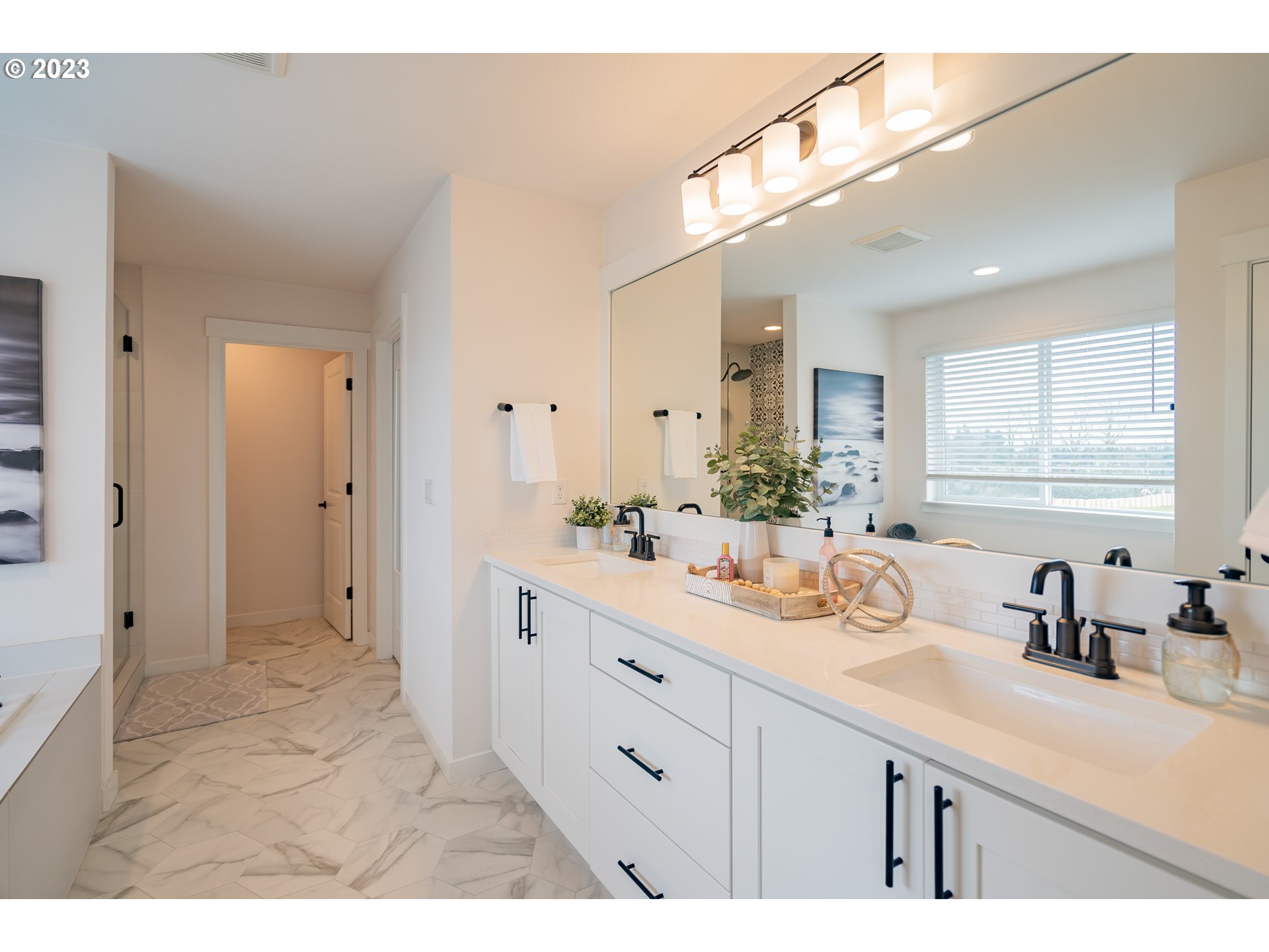8719 North 1st Street Ridgefield, WA 98642 - Photo 38 of 45 a spacious bathroom with a sink a mirror and a shower