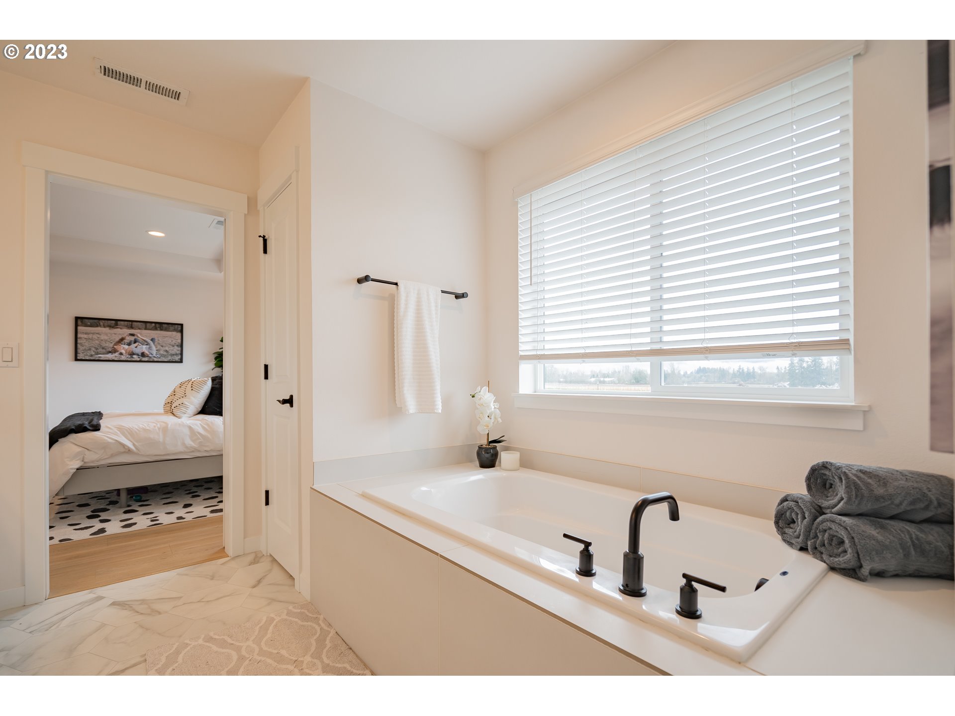 8719 North 1st Street Ridgefield, WA 98642 - Photo 40 of 45 a bathroom with a bathtub sink and a window