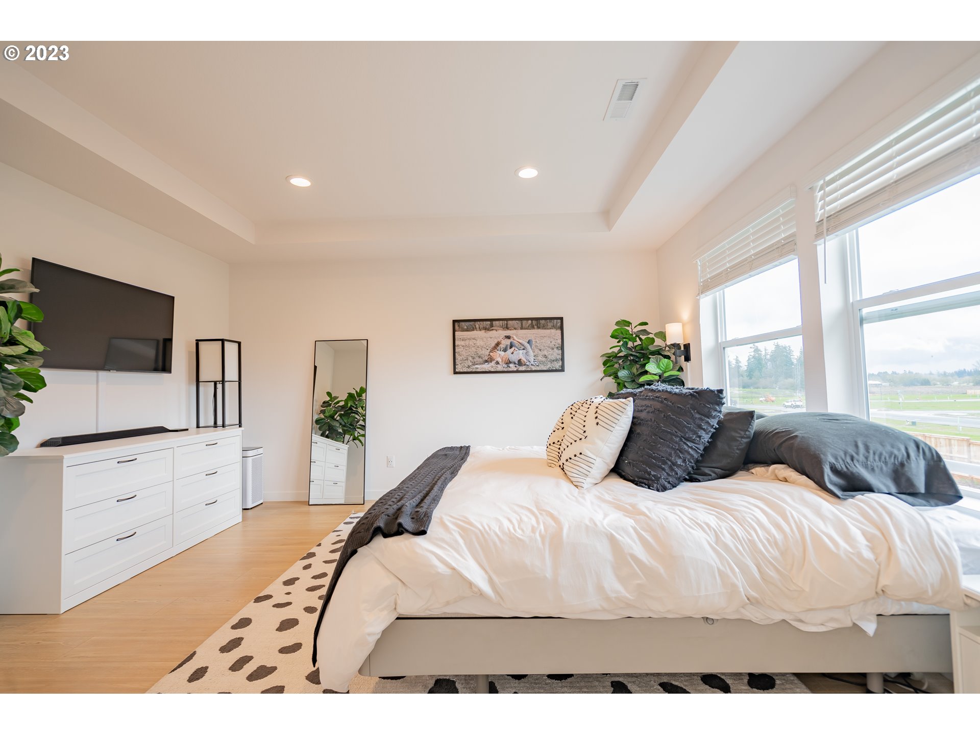 8719 North 1st Street Ridgefield, WA 98642 - Photo 43 of 45 a bedroom with a large bed and a flat screen tv