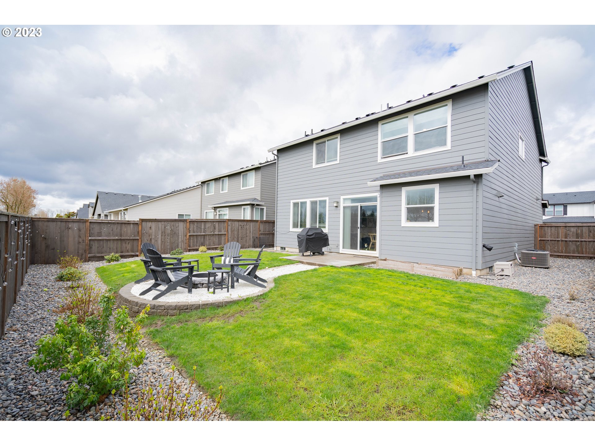 8719 North 1st Street Ridgefield, WA 98642 - Photo 45 of 45 a view of a backyard with table and chairs potted plants and wooden fence