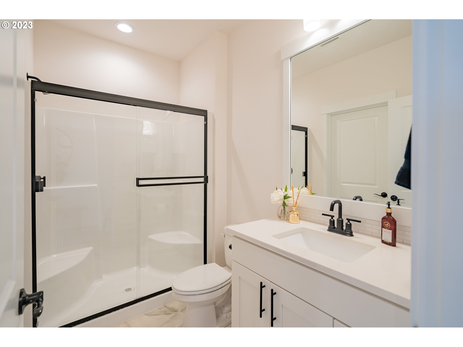 8719 North 1st Street Ridgefield, WA 98642 - Photo 5 of 45 a bathroom with a sink a toilet a mirror and shower